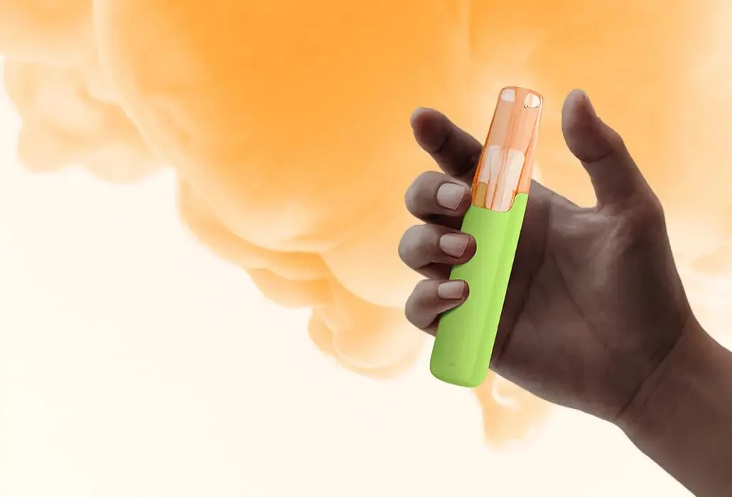 A hand holding a Snowplus Dash against an orange cloud.